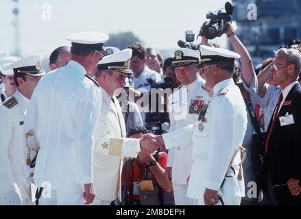 A rear admiral greets Soviet Pacific Fleet commander ADM Gennadiy Khvatov as U.S. Pacific Fleet commander ADM Charles R. Larson, left, and VADM John H. Fetterman Jr., commander, Naval Air Force, U.S. Pacific Fleet, stand by. Three ships of the Soviet Pacific Fleet are in port on a five-day goodwill visit. Base: Naval Air Station, San Diego State: California (CA) Country: United States Of America (USA) Stock Photo