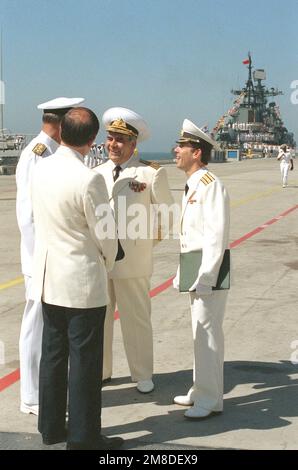 Adm. Charles R. Larson, left, commander in chief, U.S. Pacific Fleet, speaks through an interpreter to Adm. Gennadiy Khvatov, second from right, commander, Soviet Pacific Fleet, following the arrival of three Soviet ships for a five-day goodwill visit. Base: Naval Air Station, San Diego State: California (CA) Country: United States Of America (USA) Stock Photo