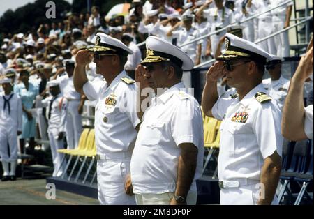 Admiral (ADM) Charles R. Larson, left, Commander in CHIEF, United States (US) Pacific Fleet; ADM Gennadiy Khvatov, Commander, Soviet Pacific Fleet; and an unidentified US Navy captain salute as the colors are presented during a ceremony held in honor of ADM Khvatov. Three ships of the Soviet Pacific Fleet are in San Diego for a five-day goodwill visit. Base: Naval Air Station, San Diego State: California (CA) Country: United States Of America (USA) Stock Photo