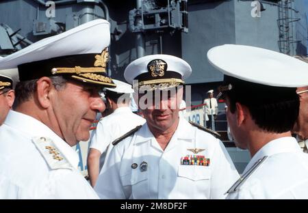 Vice Admiral (VADM) John H. Fetterman Jr., center, Commander, Naval Air Force, United States (US) Pacific Fleet, listens as a translator relays the remarks of Admiral (ADM) Gennadiy Khvatov, left, Commander of the Soviet Pacific Fleet. Three ships of the Soviet Pacific Fleet are in San Diego for a five-day goodwill visit. Base: Naval Air Station, San Diego State: California (CA) Country: United States Of America (USA) Stock Photo