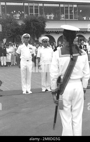 ADM Charles R. Larson, left, commander in chief, U.S. Pacific Fleet, stands at attention beside ADM Gennadiy Khvatov, commander, Soviet Pacific Fleet, during an evening colors ceremony outside the Admiral Kidd Club. Three ships of the Soviet Pacific Fleet that have come to San Diego for a five-day goodwill visit. Base: Naval Air Station, San Diego State: California (CA) Country: United States Of America (USA) Stock Photo