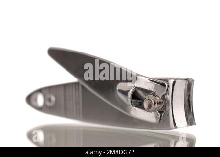 Single metal nail scissors, macro, isolated on white background. Stock Photo