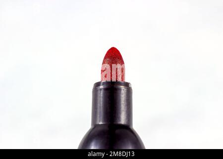 Black marker pen with bright red tip on light background close up. Stock Photo