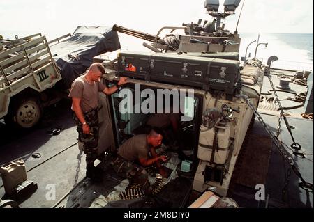 U.S. Army personnel check the rounds for an M-163 Vulcan self-propelled anti-aircraft gun. The gun, along with other equipment, is being transported to Saudi Arabia aboard the rapid-response vehicle cargo ship USNS REGULUS (T-AKR-292) in support or Operation Desert Shield. Subject Operation/Series: DESERT SHIELD Country: Unknown Stock Photo