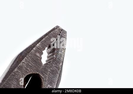 Old rusty metal pliers repair tool on light background close up with copy space. Stock Photo