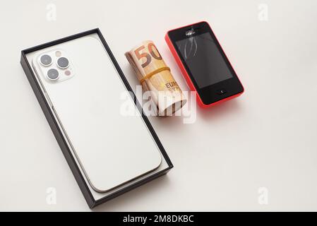 New smartphone on table next to the old phone, Buying a new phone Stock Photo