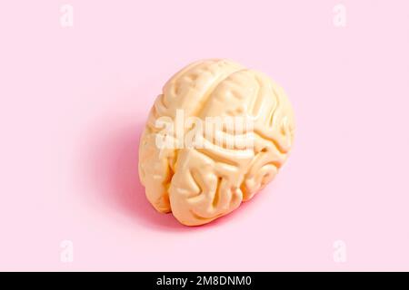 Pink human brain on pastel background. Psychology and mental health concept. Stock Photo
