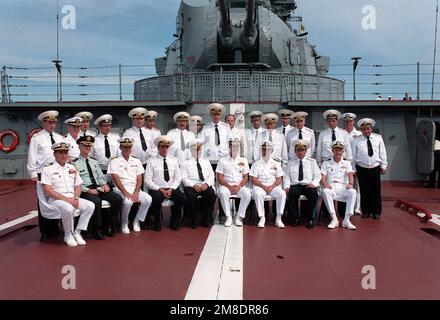 US and Soviet officers gather on the stern of the Soviet nuclear-powered guided missile cruiser FRUNZE during a visit to the city by the guided missile cruiser USS PRINCETON (CG-59) and the guided missile frigate USS REUBEN JAMES (FFG 57). Admiral Charles R. Larson, Commander in CHIEF, US Pacific Fleet, is seated over the white stripe. He is flanked by Vice Admiral John H. Fetterman Jr., right, Commander, Naval Air Force, US Pacific Fleet, and Admiral Gennadi Khvatov, Commander, Soviet Pacific Fleet. Base: Vladivostok State: Siberia Country: U.S.S.R. (SUN) Stock Photo