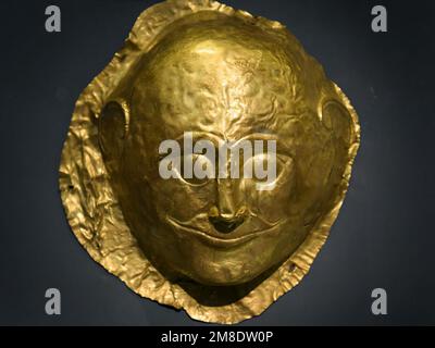 Athens - May 7, 2018: Gold artifact, mask from Ancient Greek Mycenae in National Archaeological Museum of Athens, Greece. Theme of treasure, history, Stock Photo