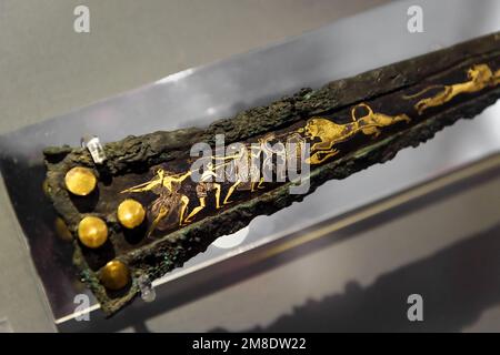 Athens - May 7, 2018: Bronze sword with gold inlays, artifact from Greek Mycenae (Mykines) in National Archaeological Museum of Athens, Greece. Histor Stock Photo