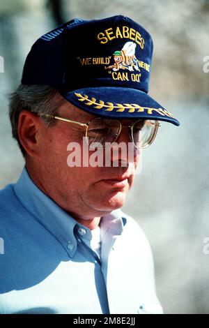 Secretary of the Navy H. Lawrence Garrett III sports a construction battalion cap as he visits a Seabee unit during Operation Desert Shield. Subject Operation/Series: DESERT SHIELD Country: Bahrain (BHR) Stock Photo