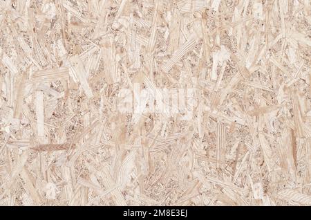 Textured OSB board close-up. Can be used as an abstract background with space. Stock Photo