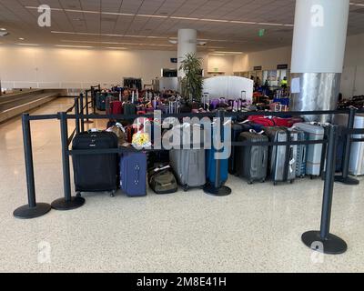 Unclaimed luggage is piling up at San Jose Mineta International Airport terminal due to canceled or delayed flights - San Jose, California, USA - Dece Stock Photo