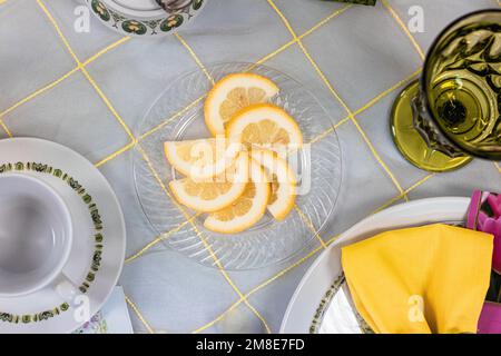 lemon slices arranged on a clear plate at a tea party Stock Photo
