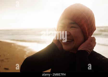 portrait of Asian woman ready to swim in the cold sea Stock Photo