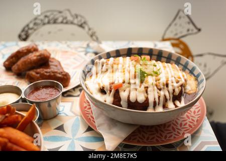 Mexican burrito with salsa and chicken wings in a restaurant Stock Photo