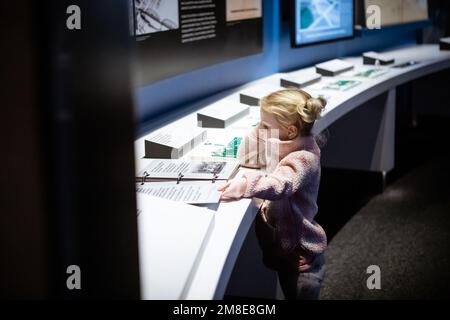 Young tourist reading information in museum exhibit Stock Photo