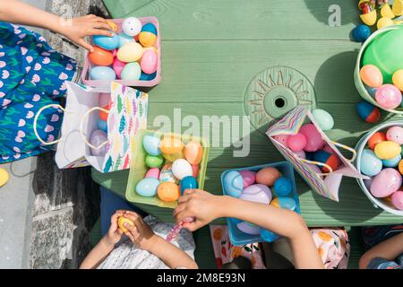 Kids sharing candy after easter egg hunt Stock Photo