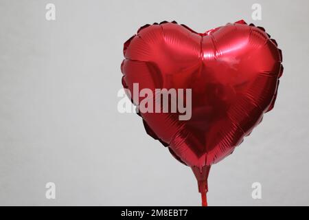 Heart shaped red inflatable balloon Stock Photo