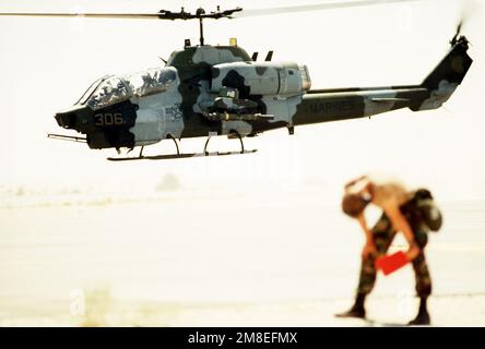 An AH-1 Sea Cobra helicopter takes off on a mission during Operation Desert Shield. Subject Operation/Series: DESERT SHIELD Country: Saudi Arabia (SAU) Stock Photo