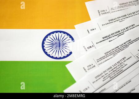 KYIV, UKRAINE - MAY 4, 2022 Indian income tax return blank forms on indian country flag close up. Annual tax report concept Stock Photo