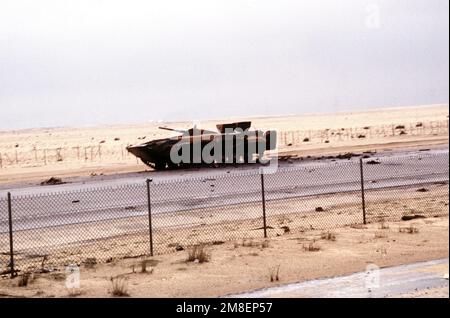 A destroyed Iraqi BMP-1 mechanized infantry combat vehicle lies alongside the road into Kuwait City during the ground phase of Operation Desert Storm. Subject Operation/Series: DESERT STORM Country: Kuwait (KWT) Stock Photo