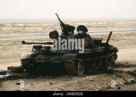 The charred remains of an Iraqi T-55 main battle tank lies abandoned ...