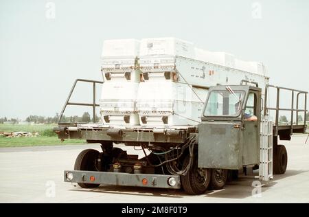 A K-Loader carrying BGM-109 Tomahawk cruise missiles rolls down a taxiway. The Tomahawks are being flown back to the U.S. after being deployed during Operation Desert Storm. Subject Operation/Series: DESERT STORM Base: Naval Air Station, Sigonella State: Sicily Country: Italy(ITA) Stock Photo