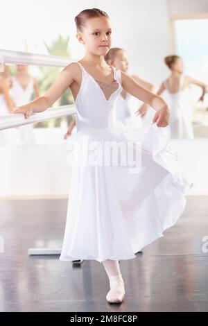 Dancing her way to the head of the class. a group of young ballerinas practicing in the studio. Stock Photo