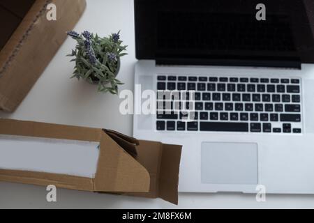 Shopping online e-comerce, Parcel boxes on a laptop. Stock Photo