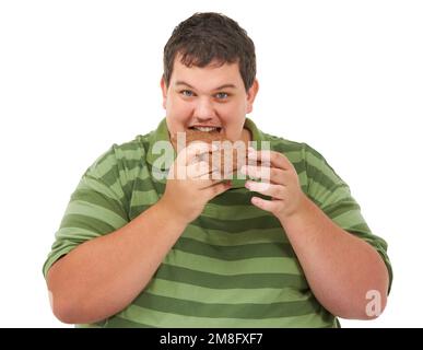 Does the body...no good. An obese young man looking at the camera and biting into a slab of chocolate. Stock Photo