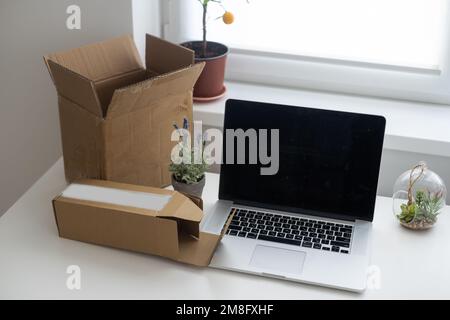 Shopping online e-comerce, Parcel boxes on a laptop. Stock Photo