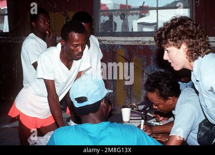 U.S. military personnel process paperwork for Haitian refugees at Camp McCalla, site of a humanitarian relief center for Haitians fleeing political and economic upheaval in their homeland. Base: Guantanamo Bay Country: Cuba(CUB) Stock Photo