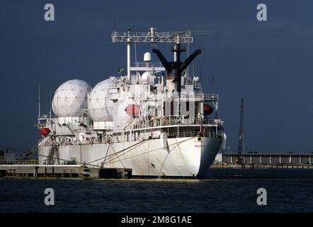 A starboard bow view of the missile range instrumentation ship USNS REDSTONE (T-AGM 20) moored to a pier near the center.. Base: Kennedy Space Center State: Florida(FL) Country: United States Of America(USA) Stock Photo