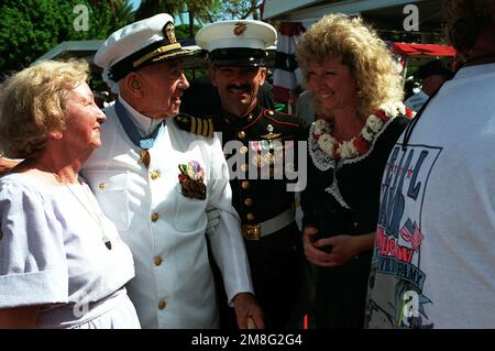 CAPT. Donald K. Ross, USN (Ret.) and Mrs. Ross converse with MASTER SGT. Roger Roll and his wife following the dedication of the USS NEVADA Memorial at Hospital Point. The ceremony is part of an observance commemorating the 50th anniversary of the Japanese attack on Pearl Harbor. Ross is a survivor of the Pearl Harbor attack and a Medal of Honor recipient while Roll is a veteran of Operation Desert Storm. Base: Pearl Harbor State: Hawaii(HI) Country: United States Of America (USA) Stock Photo