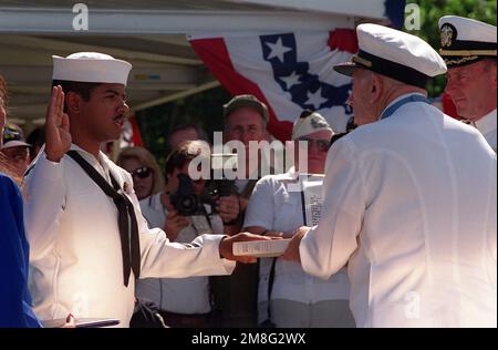 CAPT Donald K. Ross, USN (Ret.), a survivor of the Japanese attack on Pearl Harbor and a Medal of Honor recipient, re-enlists PO Don Bray during the dedication of the USS NEVADA Memorial at Hospital Point. The ceremony is taking place as part of an observance commemorating the 50th anniversary of the Japanese attack. Base: Pearl Harbor State: Hawaii(HI) Country: United States Of America (USA) Stock Photo