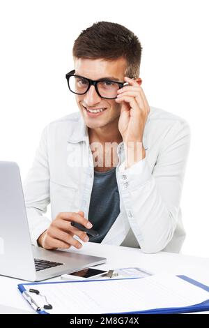 Working hard. A man with hipster glasses working on his laptop. Stock Photo