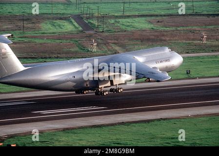 A right side view of a 75th Airlift Squadron (75th AS) C-5B Galaxy aircraft landing on base. Base: Travis Air Force Base State: California (CA) Country: United States Of America (USA) Stock Photo