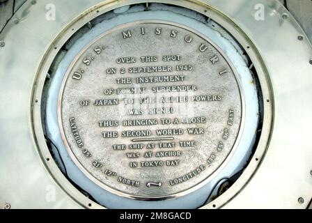 A close-up view of the plaque aboard the battleship USS MISSOURI (BB-63) that commemorates the end of World War II. The official surrender by Japan took place aboard the MISSOURI on Sep. 2, 1945, with Shigemitsu Mamoru, representative of the Japanese emperor, signing surrender documents in the presence of ADM Chester Nimitz, representing the United States Navy, and GEN Douglas MacArthur, acting as the supreme commander of Allied forces for the proceeding. Base: Naval Air Station, Long Beach State: California(CA) Country: United States Of America (USA) Stock Photo