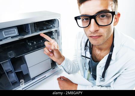 This is the problem with your device. Portrait of a technician working with wires on fixing an electrical appliance. Stock Photo