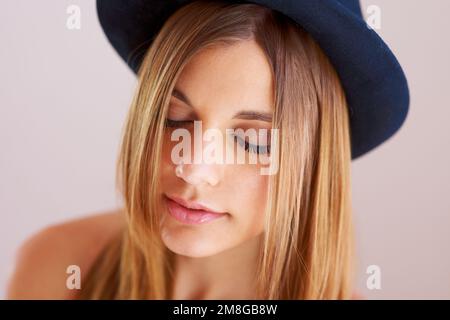 A moment of stillness. A gorgeous young woman wearing a hat with eyes closed. Stock Photo