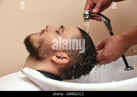 Barber washing hair of caucasian man , close-up Stock Photo