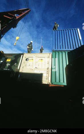 Containers holding components of a fleet hospital are placed in a ...