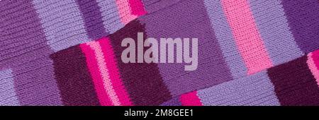 Knitted lilac background. Large knitted fabric with a pattern. Banner Stock Photo