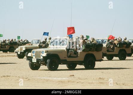 Crews of an Egyptian ranger battalion parade in Jeep light vehicles in a demonstration for visiting dignitaries during Operation Desert Shield.. Subject Operation/Series: DESERT SHIELD Country: Saudi Arabia(SAU) Stock Photo