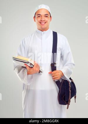 Muslim man, islamic student and standing ready for religious studying, worship or spiritual education in white background. Arabic person, happy and Stock Photo