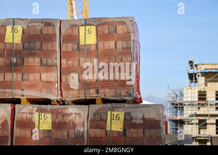 Bedburg, North Rhine-Westphalia, Germany - building material, clinker bricks packed on pallets, housing construction, new construction of multi-family Stock Photo