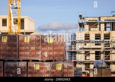 Bedburg, North Rhine-Westphalia, Germany - building material, clinker bricks packed on pallets, housing construction, new construction of multi-family Stock Photo