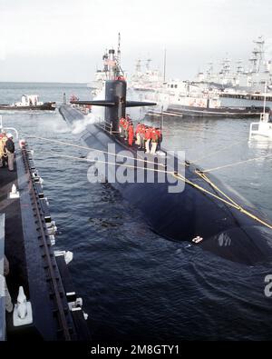 The large harbor tug USS OKMULGEE (YTB765) maneuvers a Benjamin