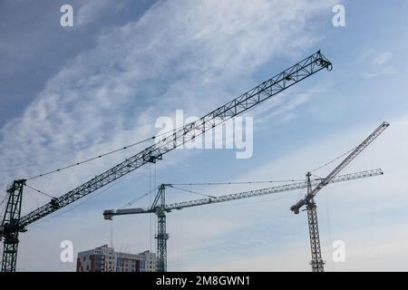 Construction cranes against the blue sky Stock Photo
